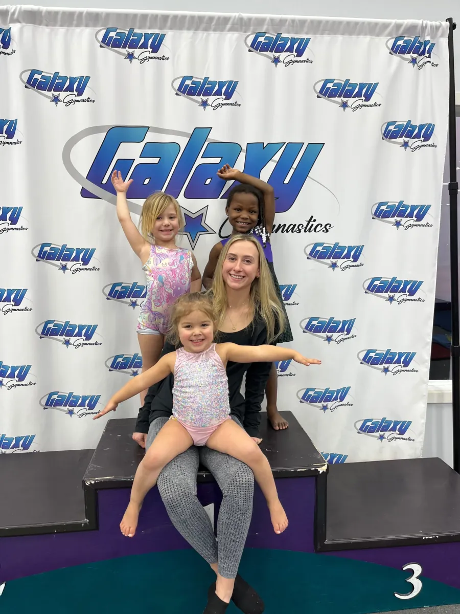Young gymnast on the podium at a Galaxy Gymnastics competition
